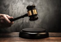 Judge's holding wooden hammer. Photo Depositphotos