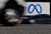 FILE PHOTO: Cars drive past a sign of Meta, the new name for the company formerly known as Facebook, at its headquarters in Menlo Park