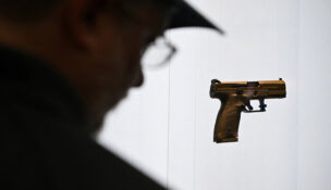 A person looks at a gun on display during the National Rifle Association’s (NRA) Annual Meetings and Exhibits in Houston, Texas, U.S. April 19, 2026. REUTERS/Callaghan O'Hare
