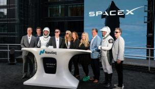 FILE PHOTO: President and COO of SpaceX Gwynne Shotwell, SpaceX CFO and President of Strategic Acquisitions Bret Johnsen, SpaceX Vice President for Human Resources Brian Bjelde, Nasdaq CEO Adena Friedman and others pose on a balcony at the Nasdaq MarketSite after the closing bell, on the day of SpaceX's initial public offering (IPO), in New York City, U.S., June 12, 2026. REUTERS/Brendan McDermid/File Photo