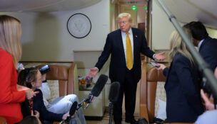 U.S. President Trump speaks to reporters mid-flight in the press cabin of the new Air Force One